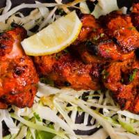 Jashan Murgh Tikka · Chicken thighs marinated overnight, roasted in a tandoor oven, served with onions, lemons, a...
