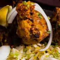 Murgh Chop · Bone-in chicken marinated in cumin-coriander marinade, roasted in a tandoor oven, and served...