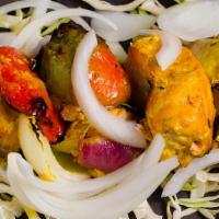 Salmon Tikka · Salmon marinated in cumin-coriander paste roasted in tandoor and served with onion, lemons, ...