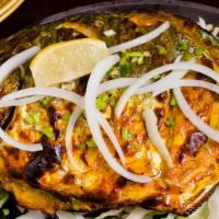 Tandoori Pomfret · Pomfret marinated in cumin-coriander paste, roasted in tandoor oven, and served with onions,...