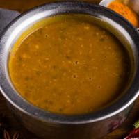 Daal Jashan · Balck creamy Lentils, slow-cooked in medium heat and topped with cilantro and ginger