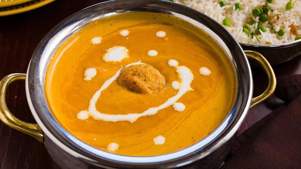 Malai Kofta · Vegetable croquettes in creamy nut sauce topped with ground cashew and milk cream