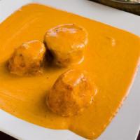 Dum Aloo · Potatoes stuffed with nuts and curried in Kashmiri style creamy tomato sauce