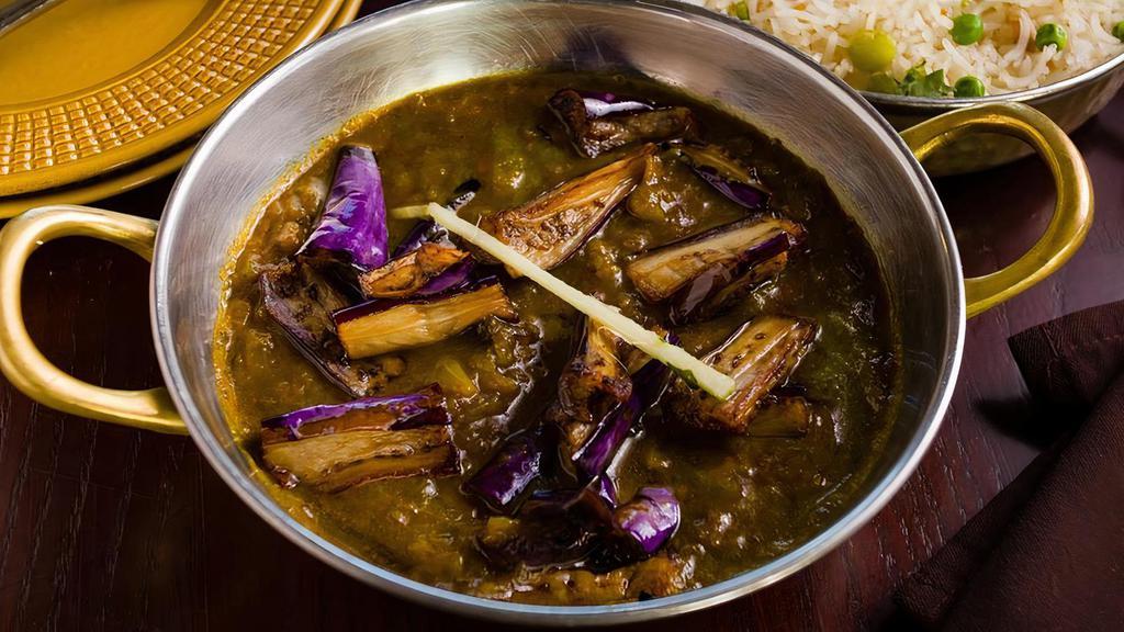 Khatte Meethe Baingan · Baby eggplant in tangy tamarind sauce topped with ginger.