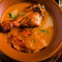 Purani Delhi Ka Butter Chicken · Bone-in chicken prepared in an Old-Delhi style buttery and creamy gravy