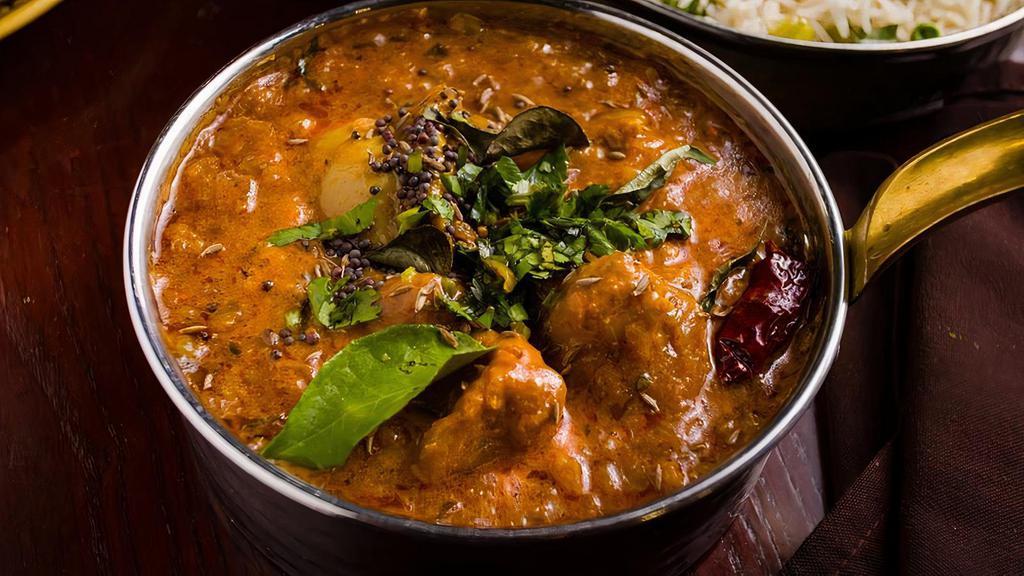 Chettinad Murgh · Chicken marinated in mustard seed, red chili, cumin, and coriander, prepared in onion and tomato gravy topped with curry leaves and dried red chili.