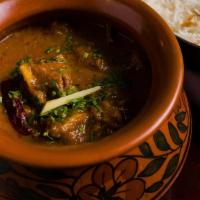 Handi Bone-In Murgh Curry · Bone-in chicken curry in onion sauce cooked in a traditional ceramic handi