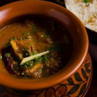 Handi Lamb Curry · Homestyle Punjabi lamb curry served in a ceramic handi.