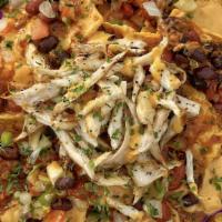 Nacho Supreme · Pile of tortilla chips topped with king oyster mushroom shreds, Credo cheeze, black beans, &...