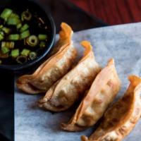 Japanese Gyoza · Four (4) pieces. Deep fried pork or veggie dumplings with dipping sauce and green onions.