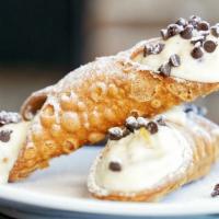 Classic Cannoli · Crispy cannoli shells filled with our own sweetened ricotta, candied citrus, and dark chocol...