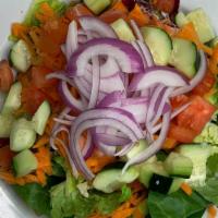House Salad · Mixed greens, carrots, onions, cucumbers & tomatoes; served with a side of  dressing.