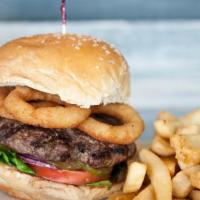 Texas Burger · 8 oz. beef patty with mixed greens, tomato, pickles, and crispy fried onion rings.