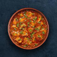 Chicken Tikka Masala · Oven-roasted chicken chunks in a rich creamy tomato and onion base gravy. Served with a port...
