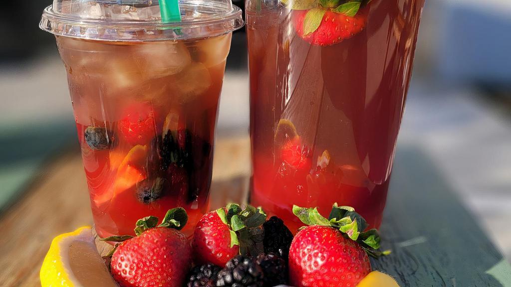 Wild Berry Iced Tea · Camellia sinensis, black tea handcrafted with pure cane sugar, fresh lemons, strawberries, blueberries, blackberries, and raspberries.