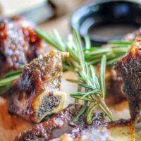 Fire Braised Beef Ribs. · Braised and grilled tender in-bone Beef ribs glazed with bourbon sauce.