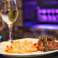 Surf And Turf   · Grilled (8pc) of shrimp and (12oz) New York Strip with beurre Blanc Sauce.