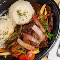 Lomo Saltado · Peruvian stir fry combing marinated beef, red onions, spring onions, tomatoes and cilantro s...