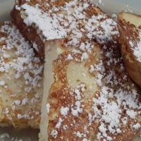 Portuguese Sweet Bread French Toast · Two slices of Portuguese sweet bread batter dipped, grilled and dusted with confectioner's s...