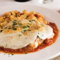 Pollo Parmese · Breaded chicken breast, sauteed, and topped with mozzarella cheese au gratin in a touch of t...