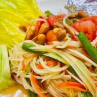 Papaya Salad · Green papaya salad served to your spice level. Mixed with thai chilies, green beans, carrot,...