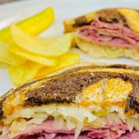 Reuben · Corned beef, sauerkraut, Swiss cheese and our house made thousand island dressing, on marble...