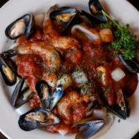Seafood Marinara · Calamari, mussels, scallops, and shrimp served with marinara sauce over linguini.