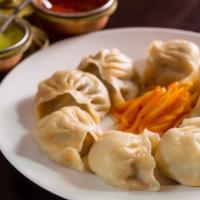 Momo · Traditional steamed dumplings made of meat, vegetables and spices.