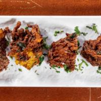 Vegetable Pakora · Mixed vegetable fritters cooked in chickpea flour batter.