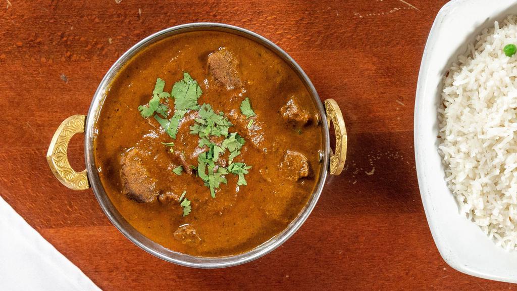 Lamb Curry · Tender meat cooked with ground and whole spices in yellow curry sauce.