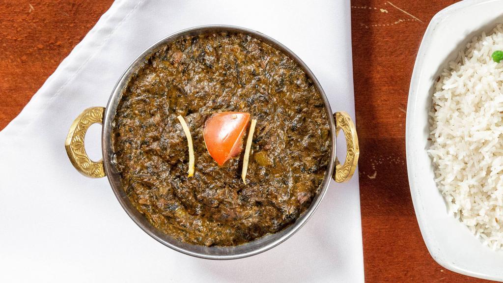 Lamb Palak · Tender meat cooked in a delicately spiced spinach purée.