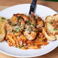 Rustic Shrimp · Pesto marinated shrimp on penne pasta tossed with rustic tomato sauce, sautéed mushrooms, co...