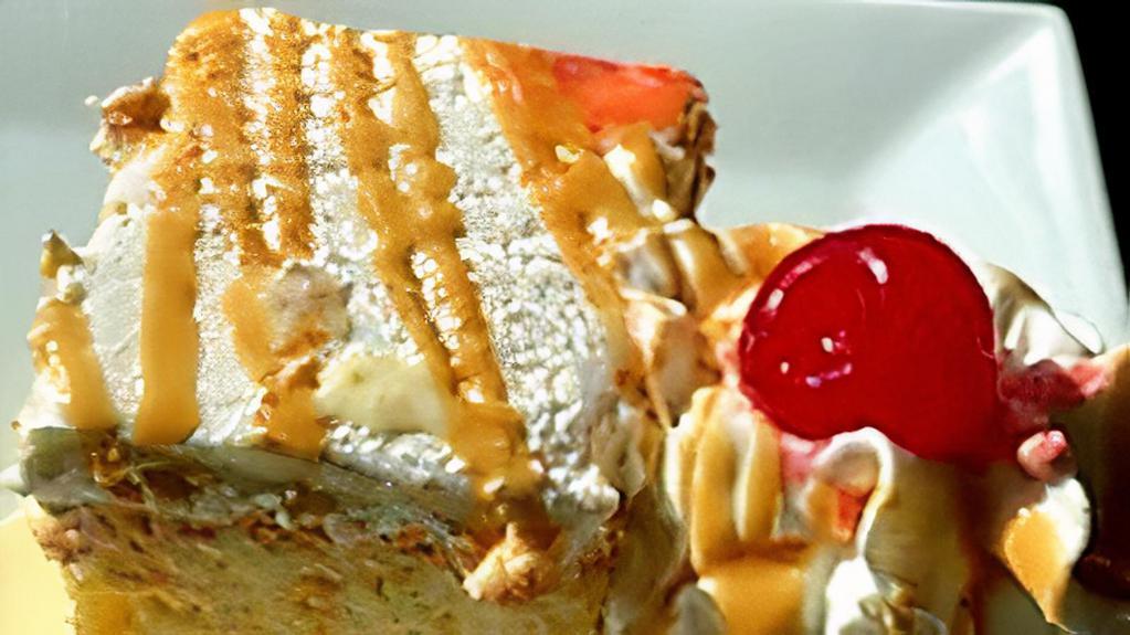 Tres Leches Cake · Sponge cake soaked in antojitos tres leches blend.