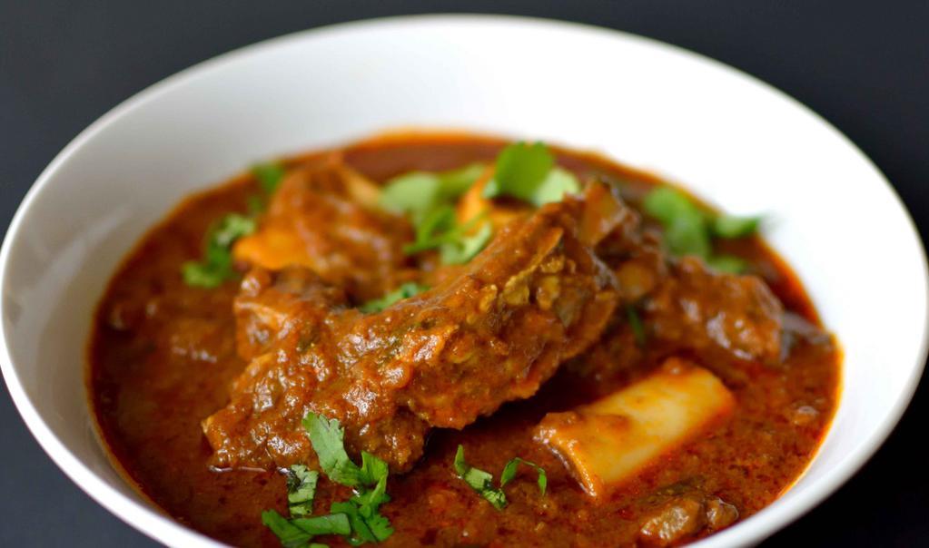 Goat Curry · Tender pieces of goat with bone cooked with herbs and spices in medium gravy. Mild to medium to taste.
