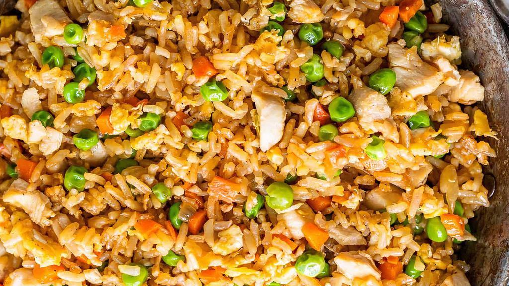 Chicken Fried Rice · Long grain basmati rice tossed with mixed vegetables, salt and pepper, chicken, and chef's own made soy sauce.