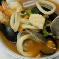 Sopa De Mariscos · Seafood soup w/ shrimp, mussels, clams, calamari, & boneless fish served w/ rice on the side
