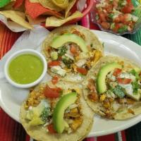 Tacos De Pescado (3) · Lightly floured fried tilapia topped w/ lettuce, pico de gallo, pineapple, cotija cheese, cr...