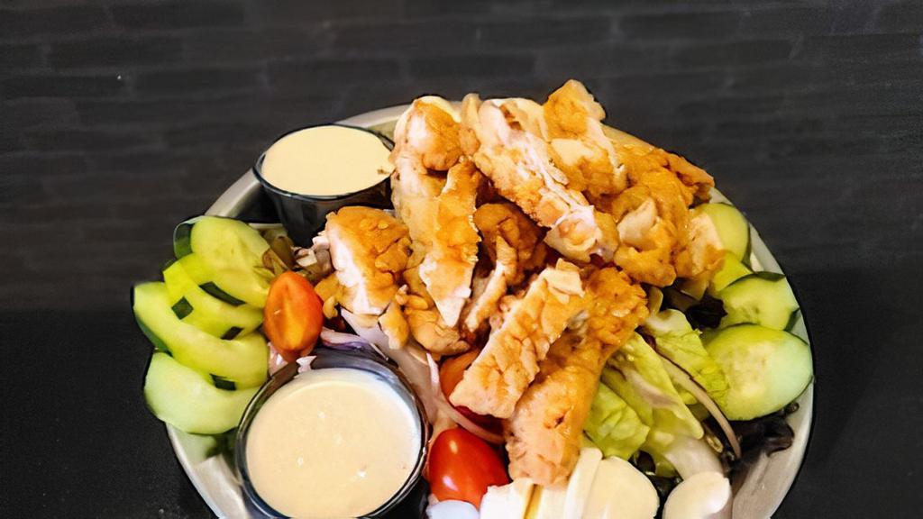 Crispy Chicken Salad · Mixed greens, tomatoes, red onions, cucumbers, chopped eggs, pepper jack cheese, topped with crispy chicken tenders. Choose your favorite dressing.