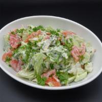 Kubansky Salad · Tomato, cucumber, onion, cilantro, parsley, dill, and garlic cream dressing.