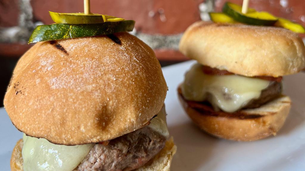 Cuban Cheeseburger Sliders · Mojo Marinated beef and pork burgers, topped with Virginia ham, Swiss cheese and dijonnaise