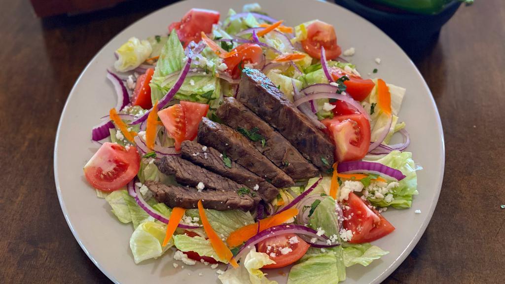 Grilled Skirt Steak Salad · Charbroiled skirt steak marinated in a special sauce served in a salad.