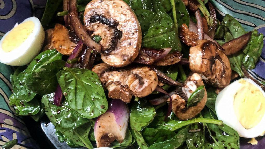 Spinach Salad · Fresh spinach, hard-boiled egg, red onion, sliced mushroom, Parmigiano tossed in a warm bacon vinaigrette.