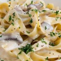 Fettuccine Alfredo · Egg noodles tossed in a Parmigiano cream sauce.