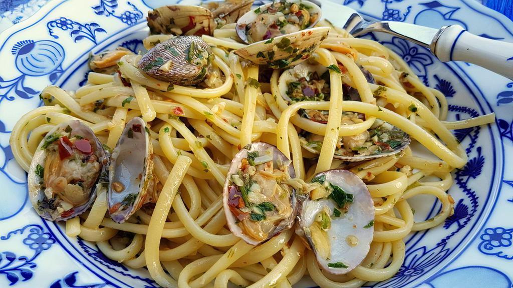 Linguine Vongole · Whole clams are sautéed with extra virgin olive oil, garlic, parsley, white wine and tossed with al dente linguine.