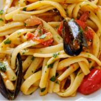 Scialatielli · Fresh homemade pasta with cherry tomatoes, arugula, shrimp, in a white wine sauce.