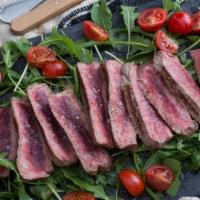 Tagliata · 16 ounces NY strip steak tuscan style simply grilled, sliced, and topped with fresh arugula,...