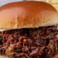 Beef Brisket Sandwich · Slow-Smoked Beef Brisket piled and topped with our BBQ sauce. Choice of chopped (includes bu...