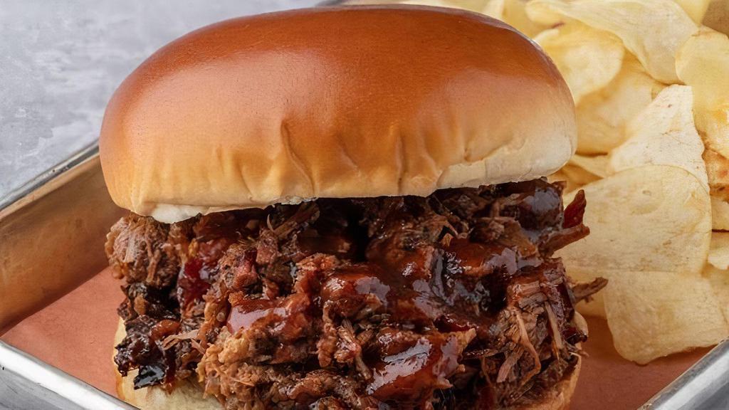 Beef Brisket Sandwich · Slow-Smoked Beef Brisket piled and topped with our BBQ sauce. Choice of chopped (includes burnt ends) or sliced. Served with potato chips