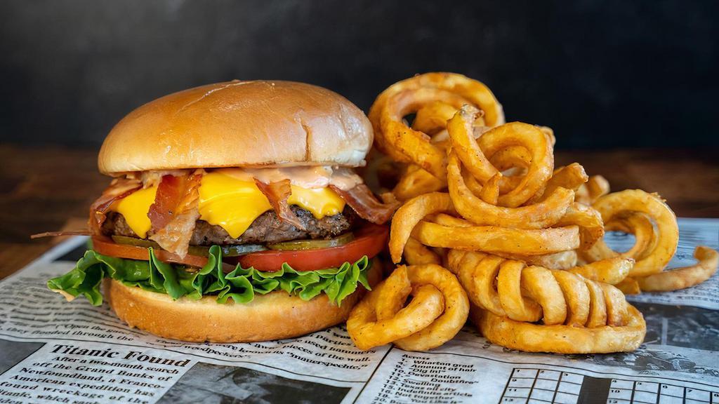 Crypto Burger · 7oz Burger Patty, American Cheese, Bacon, Cryptic Sauce, Lettuce, Tomato on a Grilled Brioche Bun
