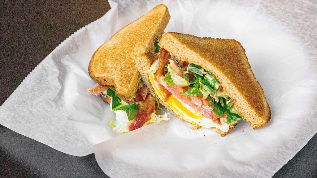 The Narragansett · 2 freshly cooked eggs,toasted wheat, american cheese, bacon, sriracha mayo, topped with lettuce and tomato